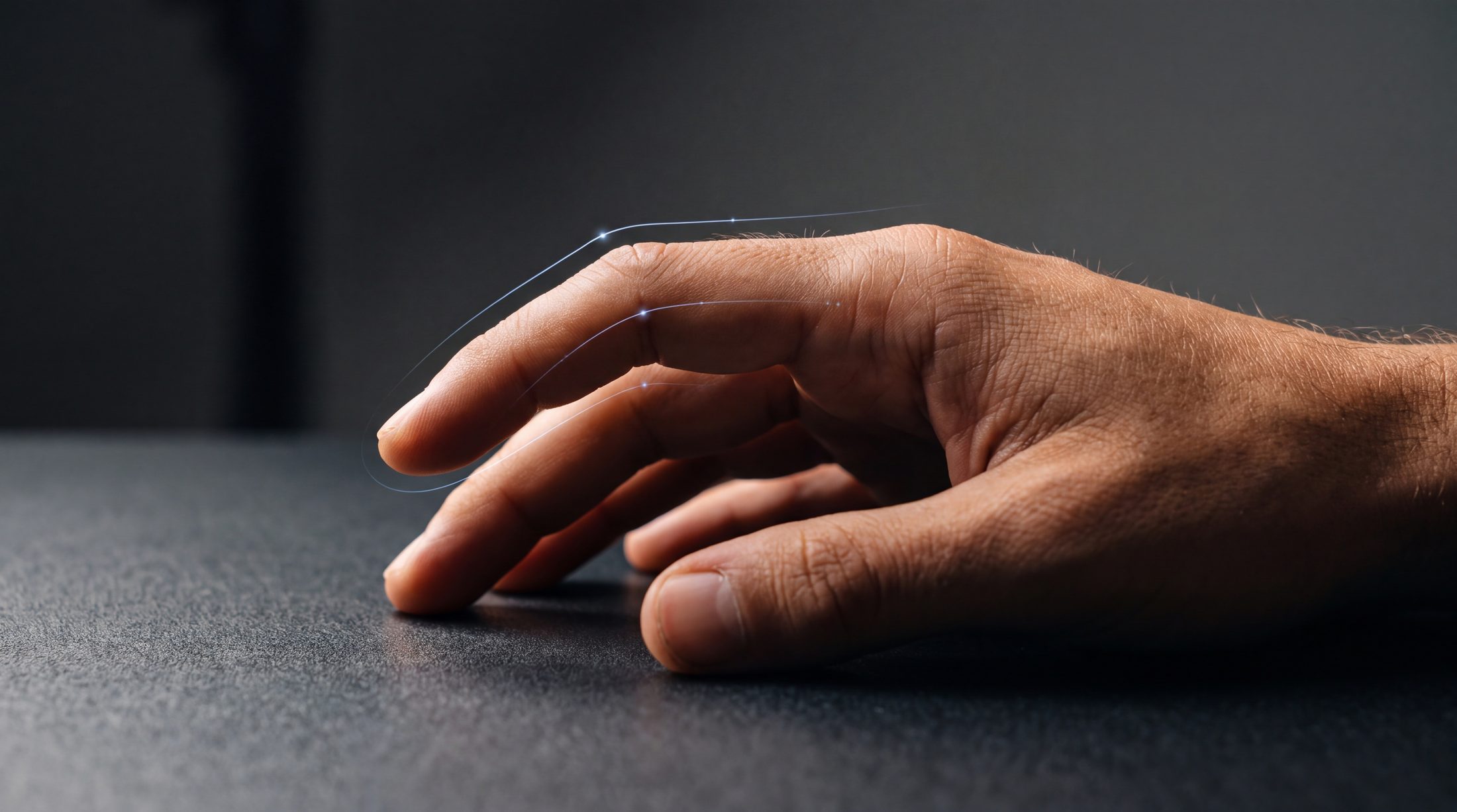 A hand beginning to move, with a faint predicted trajectory ahead of it
