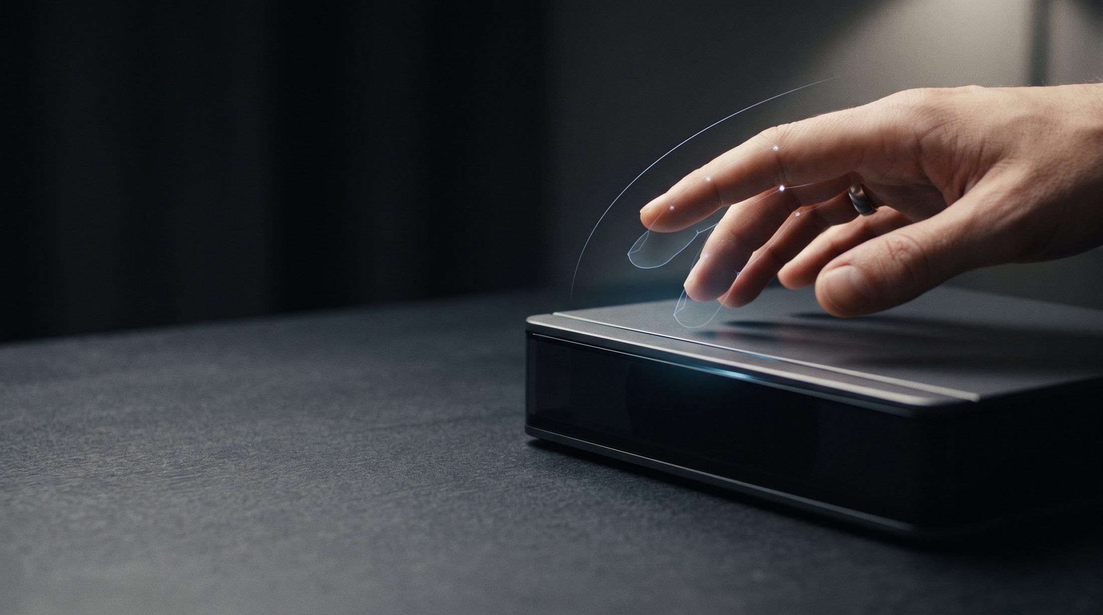 A hand gesturing above a minimal device that responds before contact